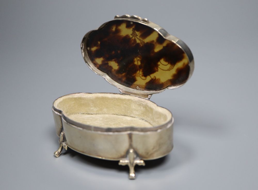 Three various tortoiseshell and silver pique-mounted glass toilet jars and a small silver circular box